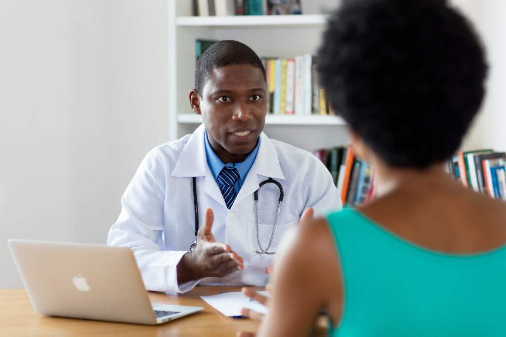 Doctor talking to patient using computer